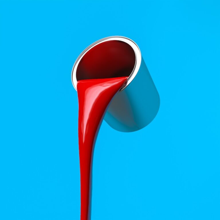 red paint poured from a metal can, blue background.